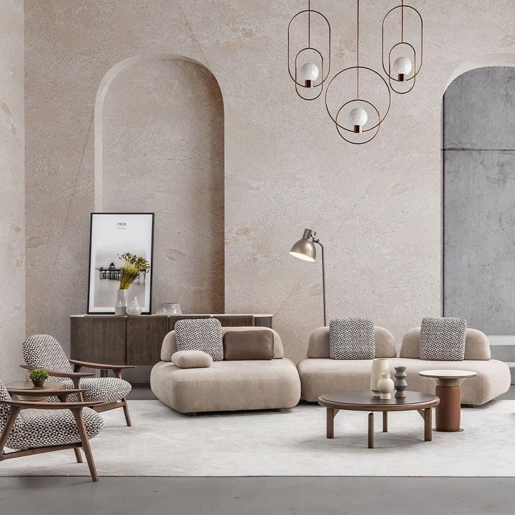 Modern living room with beige sofas, armchairs, and a coffee table in a stylish interior.